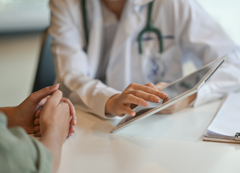 A patient consulting with a physician, with a zoomed in view of their hands