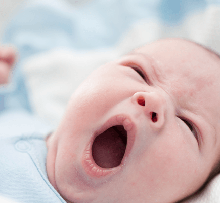 A baby yawns.