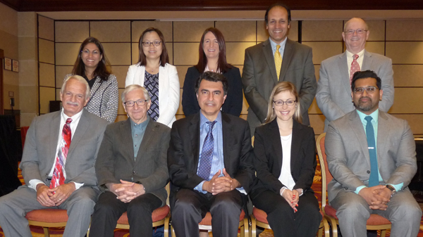 Ten speakers from the Malnutrition Blood Biomarkers Roundtable pose for a photograph.