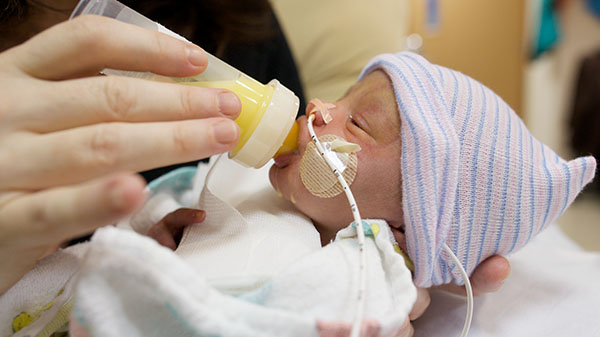 Newborn being bottle fed in hospital