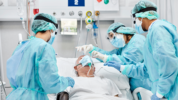 Healthcare professionals provide patient care in the ICU.