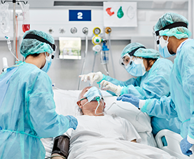 Healthcare professionals provide patient care in the ICU.