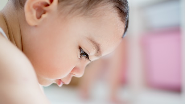 A close-up profile of a six-month old baby boy