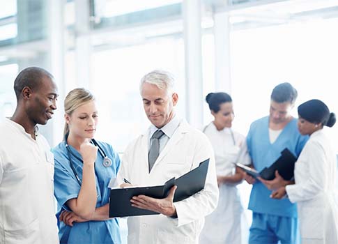 A group of healthcare professionals consult in a professional setting
