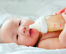 A baby with a bottle