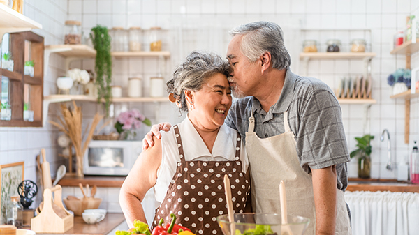 A couple cooking in the kitchen.