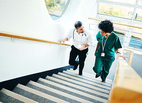 Healthcare professionals walking up a set of stairs.