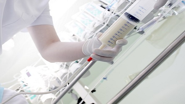 Nurse conducts tube feeding in ICU