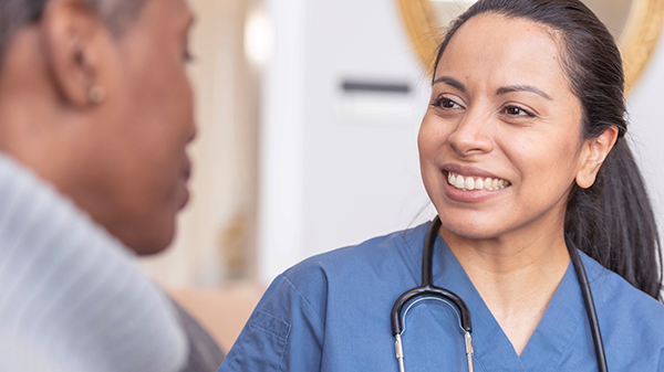 Medical professional talks with a patient.