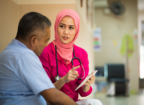 A medical professional talking to a patient.