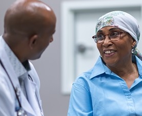 Physician consults with female cancer patient