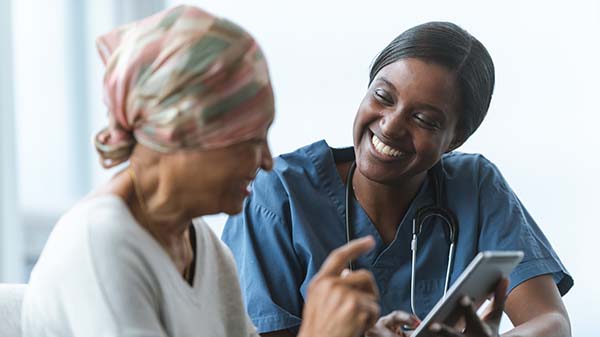 A healthcare provider meets with a cancer patient.