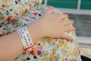 امرأة حامل مع سوار المستشفى على المعصم