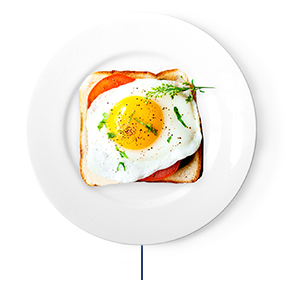 Breakfast sandwich with tomato and a sunny side up egg on top