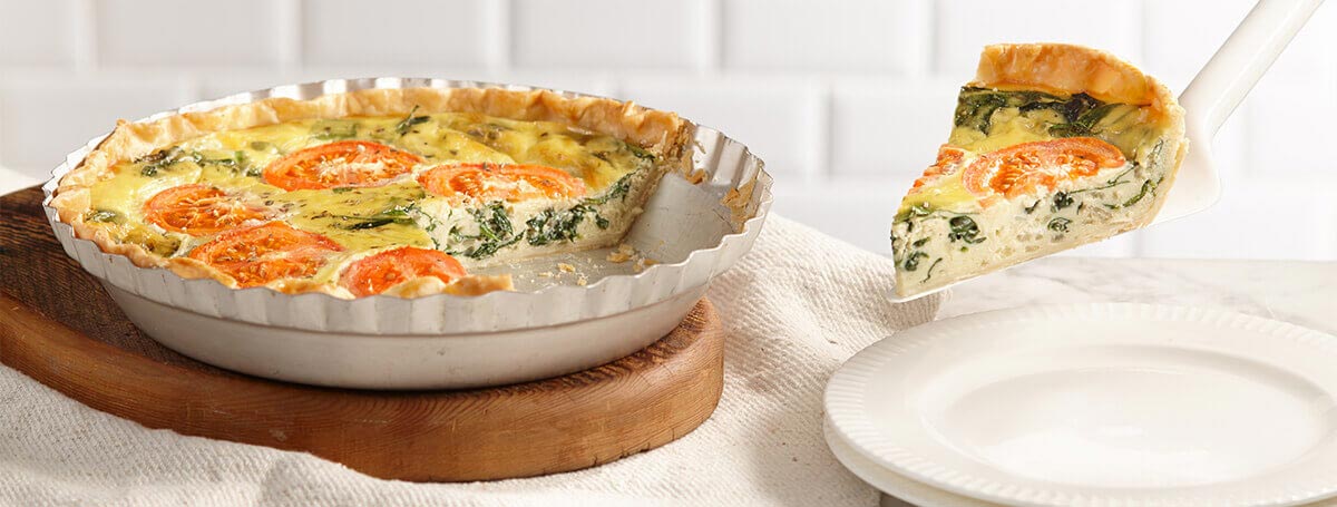 Spinach quiche recipe made with Ensure® Regular with tomatoes on top