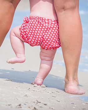 callout-mother-and-baby-feet-walking-on-a-sand-beach