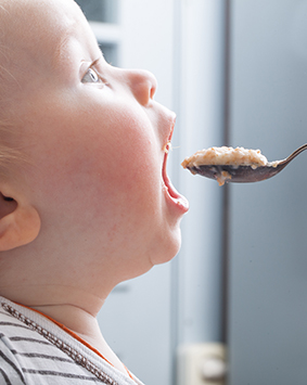 callout-mother-feeds-baby-boy-with-a-spoon
