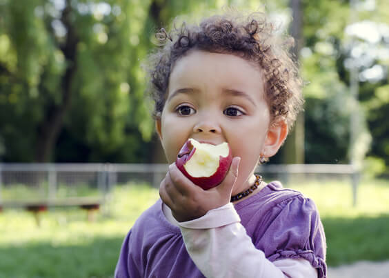 ילד אוכל תפוח בפארק